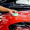 Car service worker applying nano coating on a car detail
